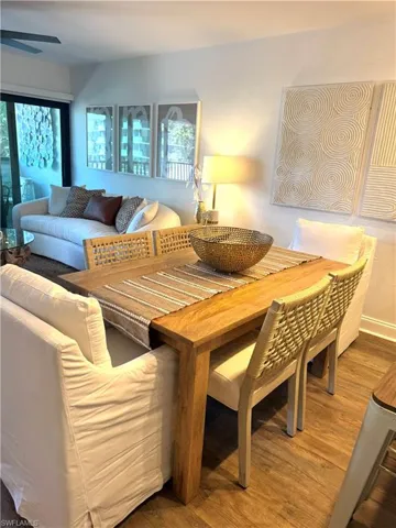 Living area with ceiling fan and wood finished floors