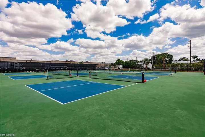 View of tennis and pickleball courts featuring fence