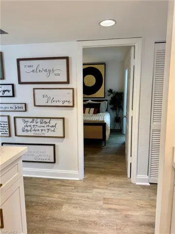 Hall featuring light wood-style floors and baseboards