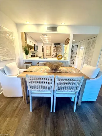 Dining room featuring visible vents, wood finished floors, and recessed lighting