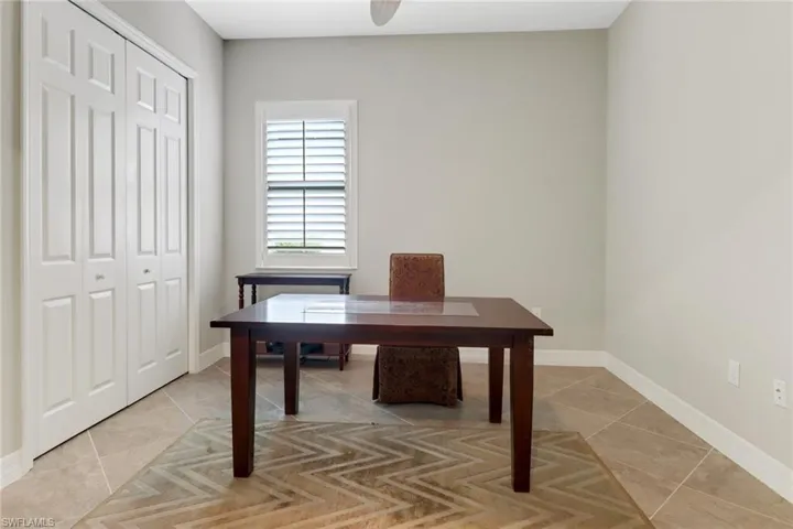 Tiled third bedroom is set up as an office
