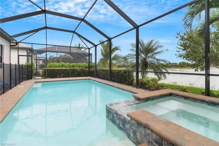 Sparkling swimming pool & spa overlooking the serene lake