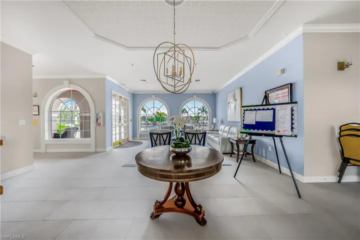 Dining room featuring ornamental molding and a chandelier