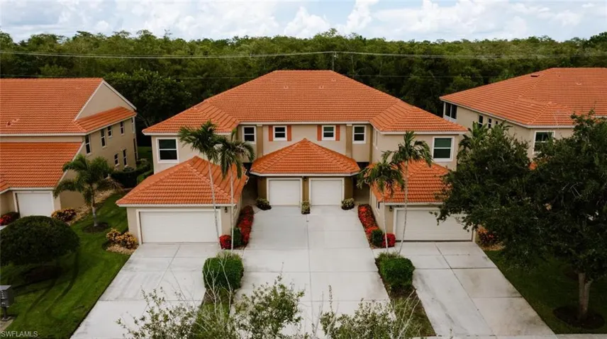 Mediterranean / spanish home with a tiled roof, driveway, stucco siding, and a garage