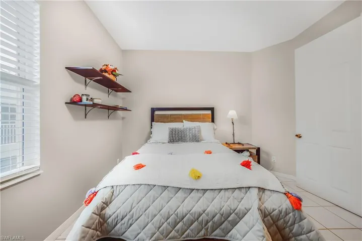 Bedroom with light tile patterned flooring