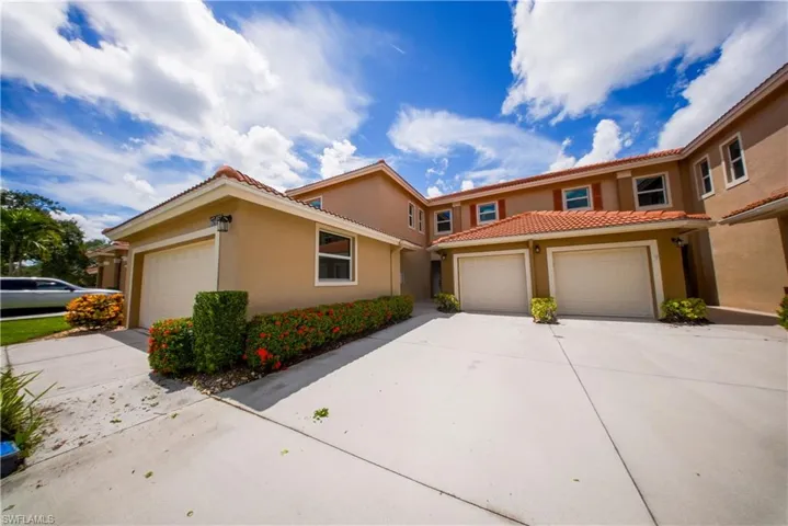 Mediterranean / spanish home with concrete driveway, stucco siding, an attached garage, and a tile roof