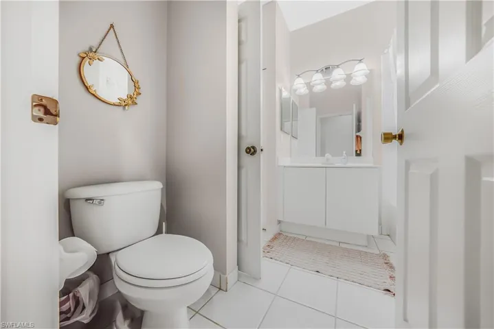 Half bathroom featuring light tile patterned floors and vanity