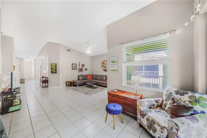 Living room featuring tile patterned flooring and a ceiling fan