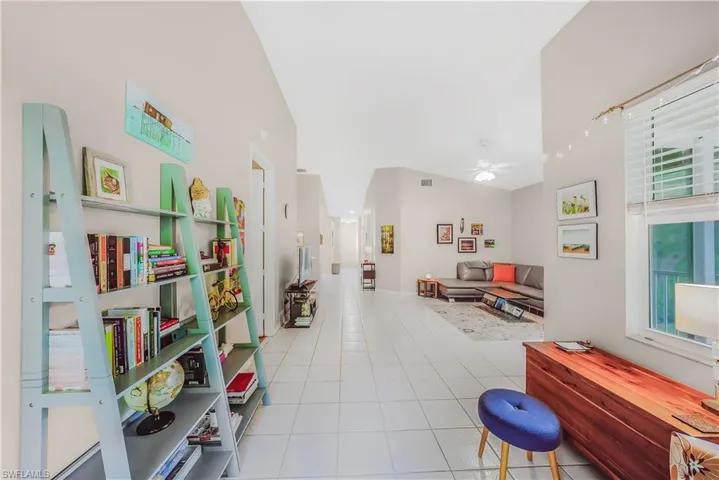 Sitting room featuring light tile patterned floors and ceiling fan