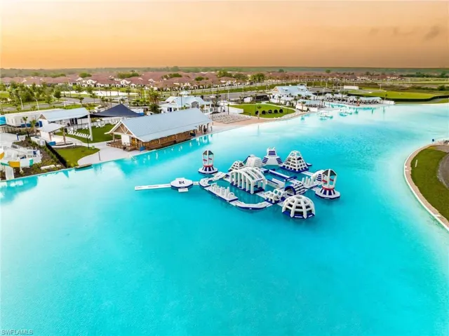 Aerial view at dusk featuring a water view