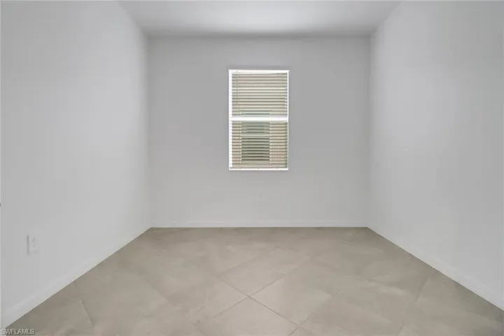 Unfurnished room featuring baseboards