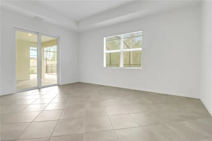 Spare room with light tile patterned flooring and baseboards