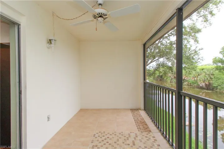 Unfurnished sunroom featuring ceiling fan