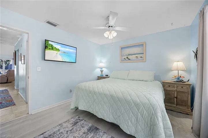 Bedroom with light wood-style floors and ceiling fan