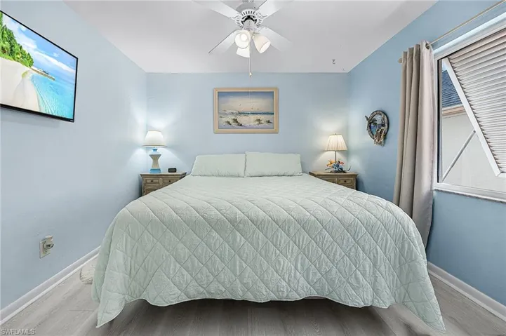 Bedroom featuring wood finished floors and a ceiling fan
