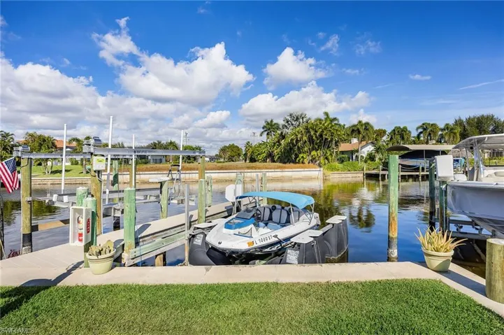 Dock area with boat lift and a water view