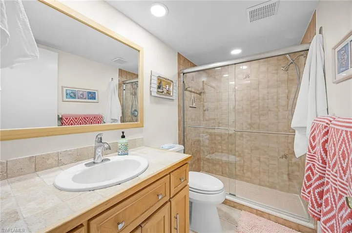Bathroom featuring vanity, a shower stall, and recessed lighting
