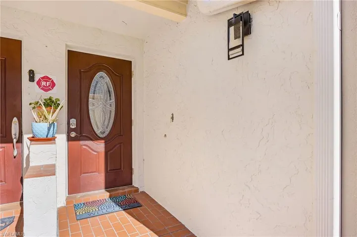Property entrance featuring stucco siding