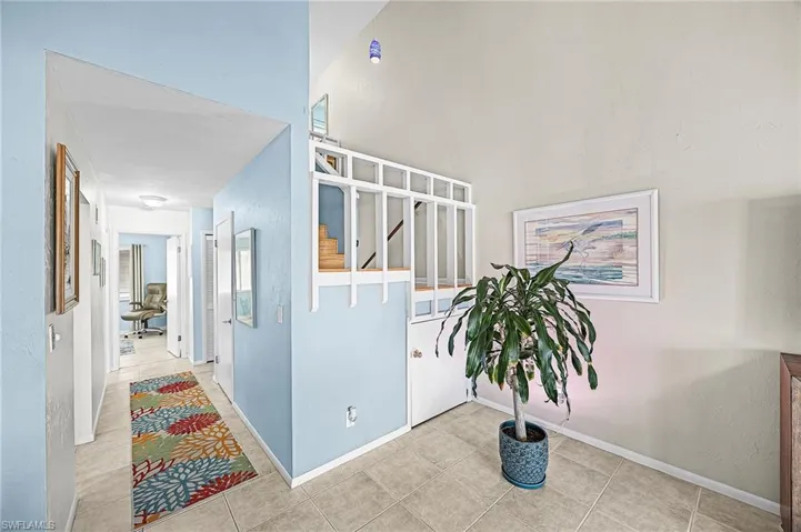 Hall with tile patterned flooring and stairs