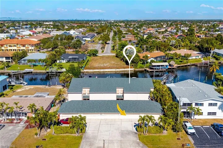 Aerial perspective of suburban area featuring a large body of water