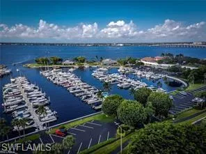 Drone / aerial view of a marina and a nearby body of water