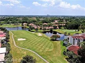Drone / aerial view of a golf club and a nearby body of water
