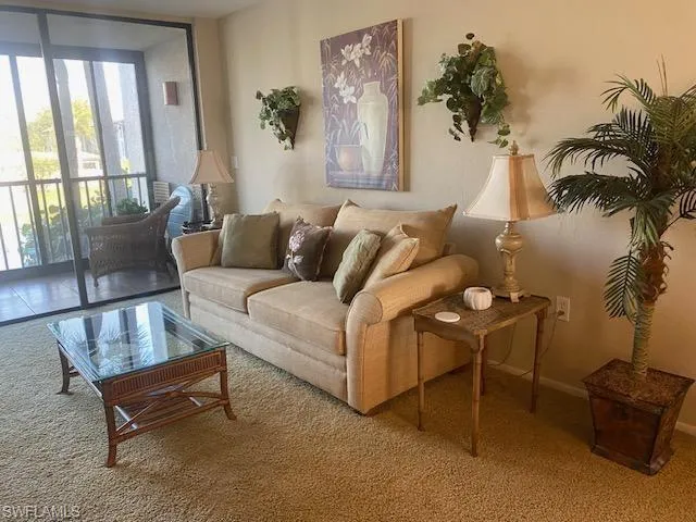 Carpeted living area featuring expansive windows