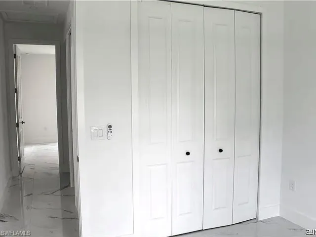 White bi-fold doors with black hardware