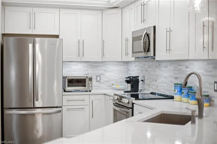 Newly Remodeled Kitchen with stainless steel appliances, White Shaker Style Cabinets and Quartz Countertops