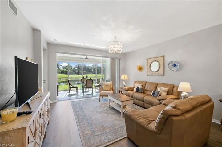 Living Room with a fabulous lake view connecting to your screened in patio.