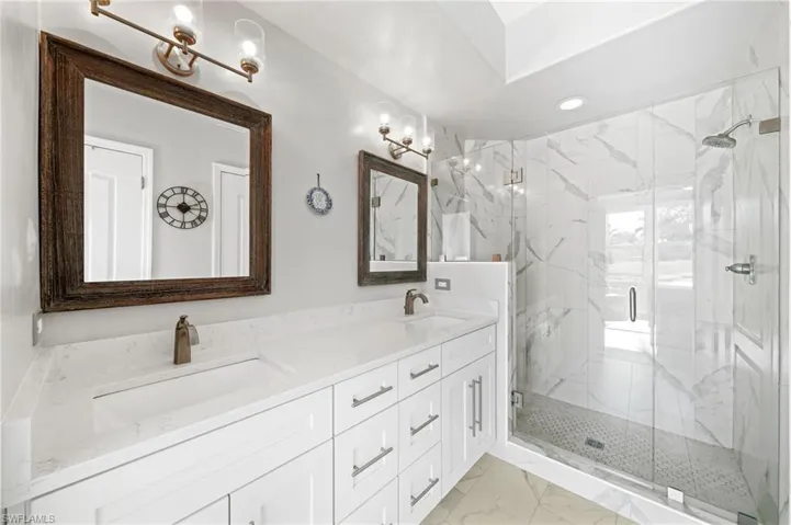 Primary Bedroom with Marble tile shower and Frameless Glass enclosure.