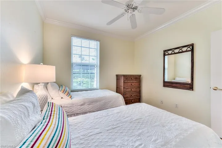 Bedroom featuring ceiling fan and ornamental molding