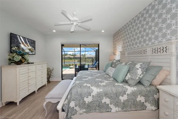 Bedroom featuring access to exterior, wallpapered walls, light wood-style floors, baseboards, and recessed lighting