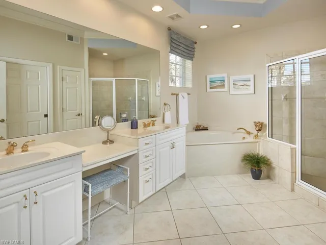 This spacious primary bathroom has two sinksand a large separate shower. There's plenty ofroom for two people to prepare for the daytogether.