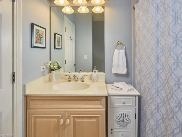 Beautifully appointed guest bath with coastal accents.