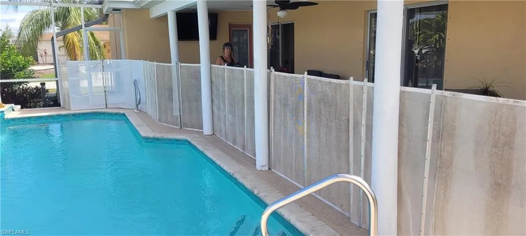 View of pool with ceiling fan