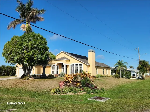 Single story home featuring a garage and a front yard