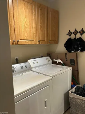 Laundry room with cabinets and washing machine and dryer