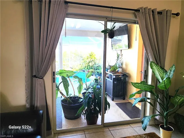 Doorway to outside featuring light tile patterned floors