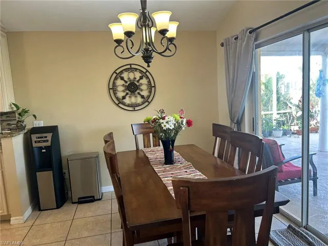Tiled dining area with a chandelier