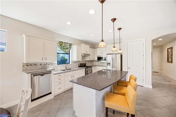 Center island with pendant lighting and extra seating can be used for daily use and for entertaining. The pantry closet will store all of your staple goods.