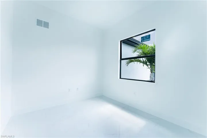 Spare room featuring tile floors