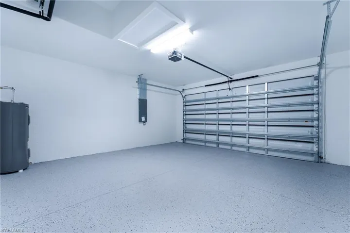 Garage with water heater and a garage door opener