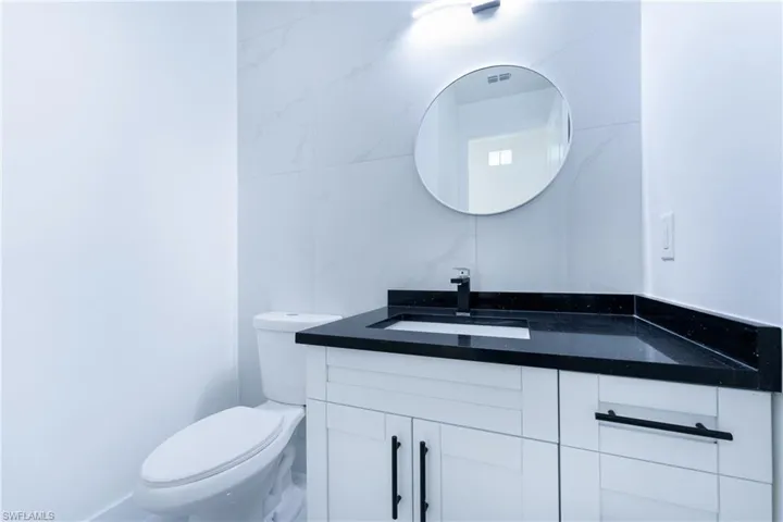 Bathroom featuring vanity and toilet