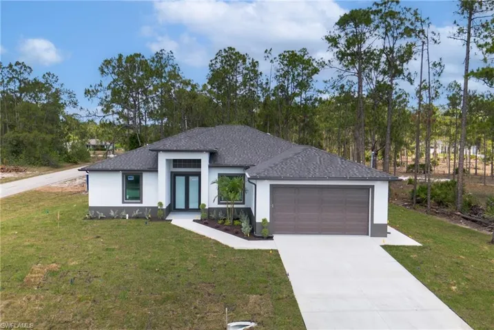 View of front of home featuring a garage and a front lawn