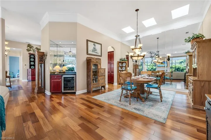 Main dining room with wall of mirrors to highlight the reflection of the outdoors!  Bar with wine cooler is located between the two family and living rooms for perfect entertaining ease.