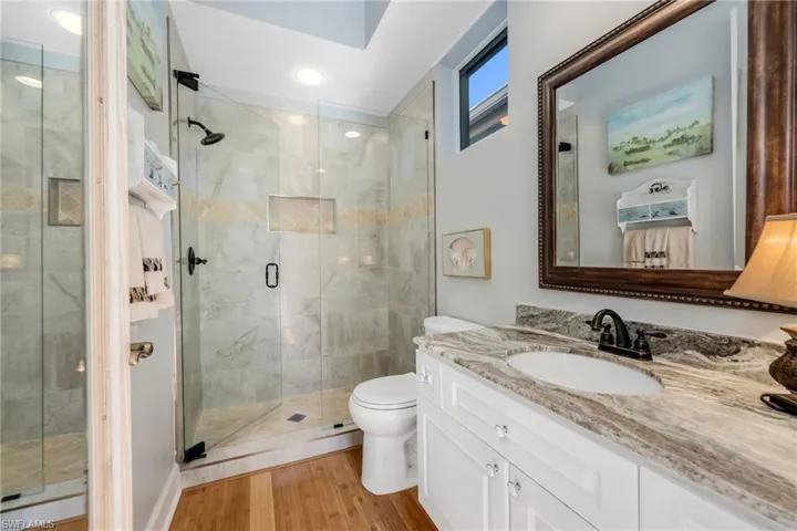 Cabana bathroom shows off the beautiful countertops, bamboo flooring and seamless glass shower enclosure. A neutral palette.