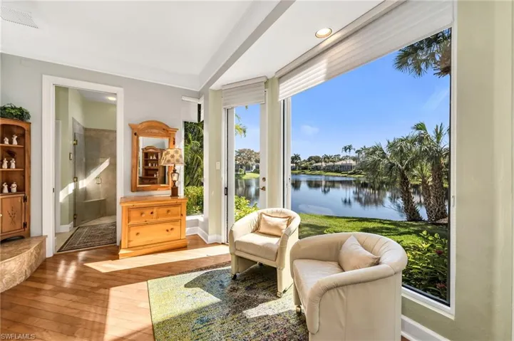 Plenty of beautiful large windows in Primary Bedroom including this sitting area to stop and enjoy the lake, wildlife, and sunrises!