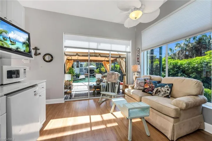 Cabana sitting room has sliders leading to courtyard/pool area, large glass windows, and plenty of sunshine!