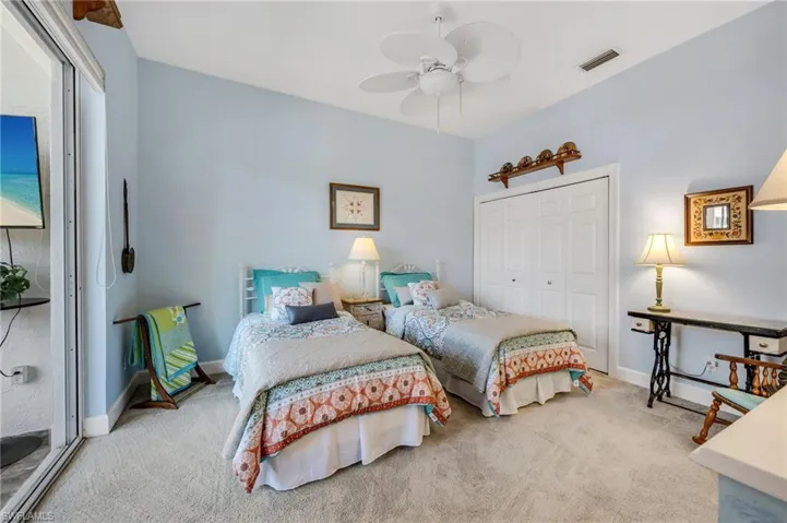 Guest bedroom located in main home.  Sliders lead to outside pool/courtyard area.